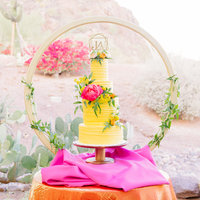 three tier yellow lemon wedding cake with pink peonies