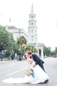 Groom dips bride in the street in Historic Downtown Charleston by Karen Schanely