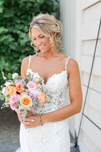 Photo of Bride looking at her flowers.