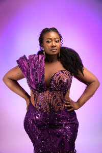 Nigerian princess posing in purple dress during photoshoot at Hacker Medias photography studio.