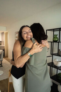 Castilia hugging her client from her Empowered Parent Coaching Program.