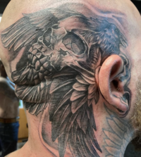 Custom black and grey skull tattoo by Dark Art Collective Tattoo Studio artist in Tacoma, WA