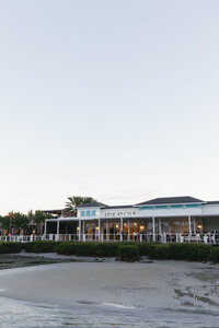 exterior shot of the pelican club at low tide where the sand is showing