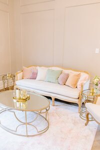 A lounge with a couch is set up in the ballroom of the Bradford wedding venue.