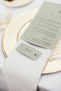 A close-up of the wedding menu, showcasing its sleek and sophisticated design, reflecting the tasteful simplicity that complements the overall elegance of the celebration