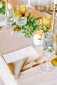 elegant table setting with a folded napkin holding a menu in century room at grbic events, a luxury wedding venue in st. louis