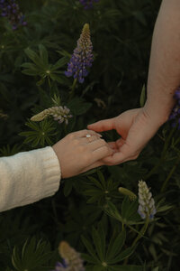 couple holding hands during lifestyle photo session in prince edward island