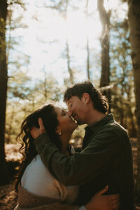 couple kissing intimately in a forest