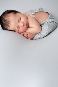 Christine-Morrison-Photgraphy-baby-boy-in-grey-overalls