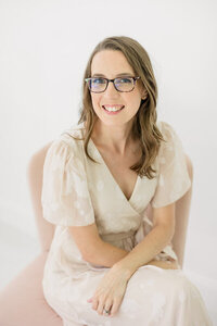 Photographer Chrissy Tundo wearing a cream dress