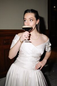 Bride sipping an espresso martini during her reception, capturing a relaxed, fun-loving wedding moment planned in the Austin Hill Country area.