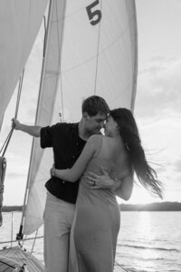 black and white image of couple on a sailboat