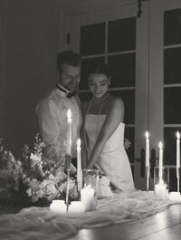 A couple cuts their cake during an intimate wedding reception.