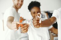 Three cancer survivors smiling and holding up cancer survivor ribbons
