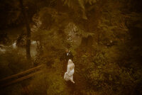 Couple exchanging vows near a picturesque waterfall in Oregon’s forests