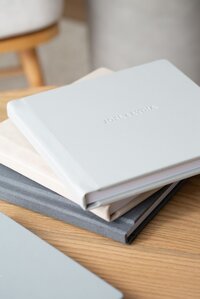 stack of linen wedding albums