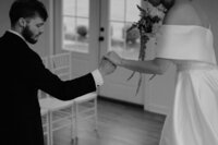 photo of a groom holding his bride's hand, helping her step down