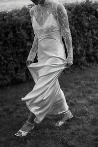 Bride's wedding dress blows in the wind during Gloucester wedding. North Shore Wedding Photographer