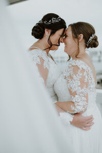 same sex couple two bride wedding with bride dresses and veils at celebrations at the bay in maryland wedding venue with wedding photography