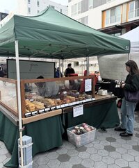 Grain Artisan Bakery booth at the Snohomish Farmers Market in 2016, where the local gluten-free bakery first shared its handmade pastries with the community.