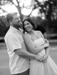 Black and white photo of Courtney Leigh and her husband with their arms around each other