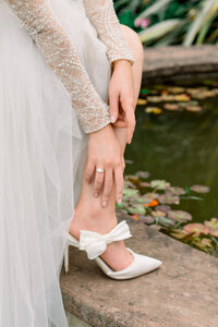 his exquisite detail shot by Tiffany Longeway features a stunning wedding ring nestled in a vintage pink ring box, symbolizing timeless love and elegance, and adding a touch of classic romance to the wedding narrative.