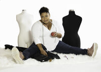 Black woman fashion designer and seamstress with mannequins