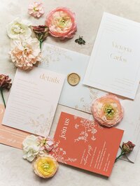 Coral and gold wedding stationery suite