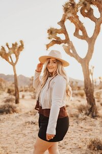 Sheila, elopement videographer and co-owner of Fearless & Brave Photography, smiling in golden-hour light.
