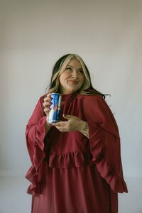 Photographer brand photo in a studio with can of red bull energy drink