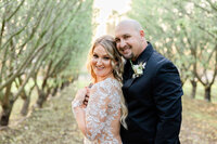 bride and groom smiling at the camera