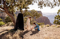 GranNewlyweds in wedding attire celebrating their elopement with a helicopter ride over the Grand Canyon.d Canyon Elopement with a Helicopter Ride