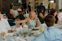 mother of the groom celebrates at her son's milwaukee wedding at the cooperage