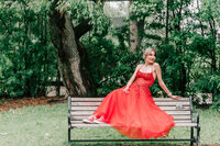 Girl in a red dress sitting on a motorcycle.