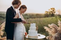 young-couple-cutting-their-wedding-cake (1)-min