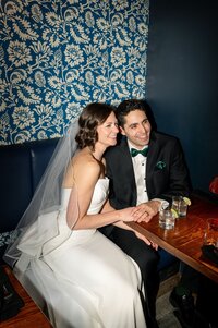 Wedding couple smiling and laughing at a bar in Halifax
