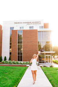 Senior walking outside Trevecca Medical facility at golden hour celebrating graduation