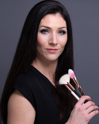 a headshot of an Ottawa makeup artist holding her brushes taken by Ottawa Branding Photographer JEMMAN Photography Commercial