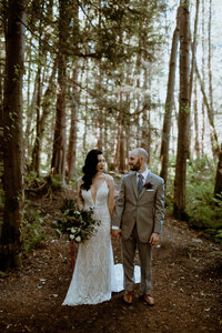 Married couple looking at each other in their backyard forest