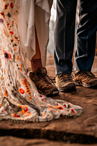 Snap shot of wedding dress and groom in blue slacks andhiking boots as the Adventure Couple Eloping in the Adirondacks