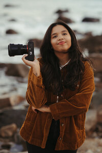 woman holding camera on hip