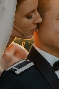bride whispering into groom's ear