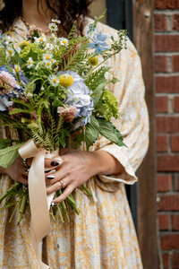 Pittsburgh wedding florist holding large bouquet 