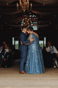 Indoor wedding with kiss in the aisle