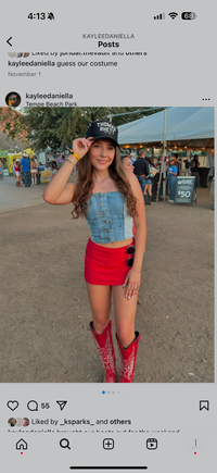 Kaylee at a country concert dressed in boots and a baseball hat