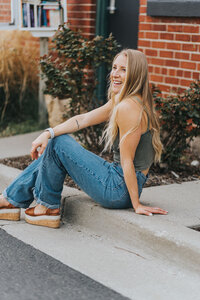 woman sitting on the curb