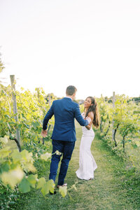 Bride and groom run through winery at Crossing Vineyards Wedding