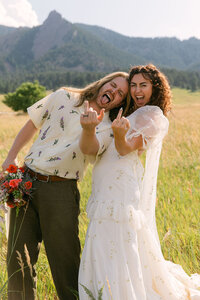 Couple showing off their wedding rings at Halfway House in Boulder during intimate micro-wedding.