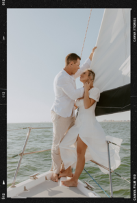 couple on sailboat during engagement photos