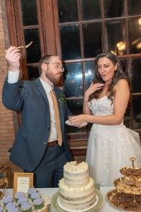 A groom and bride eat and cut their wedding cake at Main Street Station in Richmond, Va/